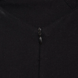 Detail of the high-quality invisible zipper on the black woven dress fabric