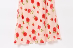 Detail of pink floral chiffon dress showing the delicate rose print and fabric texture