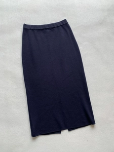 Detailed back view of navy blue knit midi skirt featuring elastic waist and hem slit