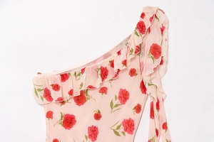 Detailed view of red rose floral print with delicate ruffles on the neckline