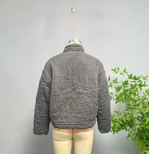 Detail view of the quilted texture and stand-up collar on this loose street jacket