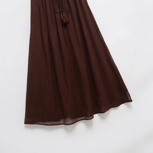 Women's deep brown pleated maxi skirt with drawstring tassel and elastic waist detail
