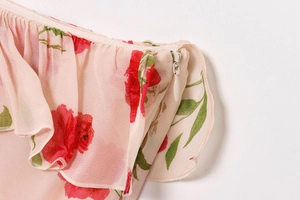 Detail of invisible zipper and tiered ruffle trim on pink floral chiffon dress