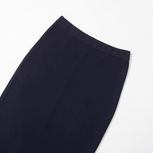 Elegant navy blue high waisted knit midi skirt featuring textured ribbed fabric and elastic waist