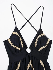 Detail of sexy backless dress with metallic ring and geometric print patterns