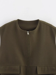 Detail of olive green wool vest showing metal zipper and large flap pockets close-up