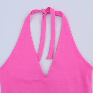 Detailed view of neon pink halter neck top with deep V-cut and smooth elastic fabric