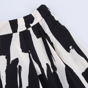 Detailed close-up of abstract black and white print fabric and waistband stitching