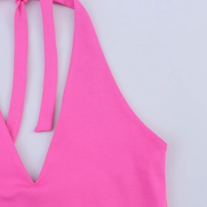 Detail view of the rose red halter neckline with delicate stitching and fabric texture