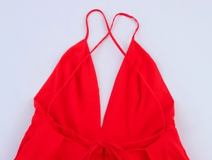 Détail de robe midi rouge à licou montrant le col en V profond et les bretelles croisées