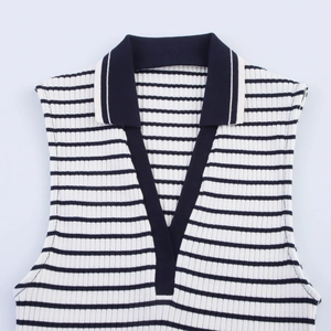 Detail of navy blue polo collar and white striped knit texture on sleeveless vest