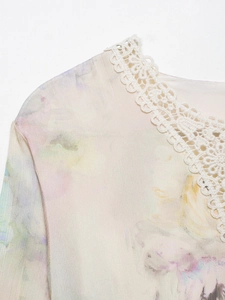 Close-up of floral print chiffon fabric with white lace trim on feminine summer dress