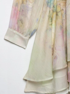 Detailed macro view of sheer floral chiffon fabric with ruffled edges and elegant pattern