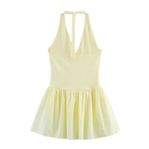 Detail of light yellow halter dress with deep V-neck and pleated ruffle hemline