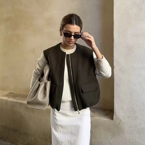 Minimalist olive green woolen vest with a stand collar and pockets in a premium style