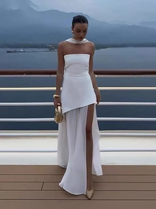 Detail of white off-shoulder maxi dress with mesh layering and high slit on cruise deck