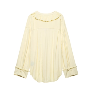 Back view of loose V-neck blouse with ruffled lace trim and asymmetric hem in pale yellow