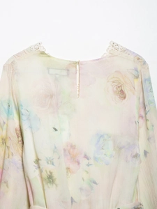 Close-up of floral chiffon dress featuring delicate lace trim and back teardrop button closure