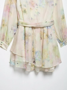 Detail of floral chiffon dress showing layered ruffles and matching waist belt