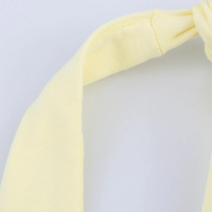 Detailed macro view of high-quality light yellow knit fabric stitching and knotted texture