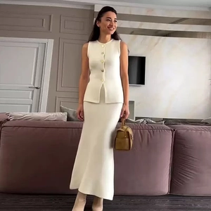 Chic cream knit set with gold button sleeveless vest and side-slit maxi skirt