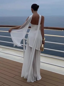 Detail of white mesh strapless dress with long flowing neck ties on a cruise deck