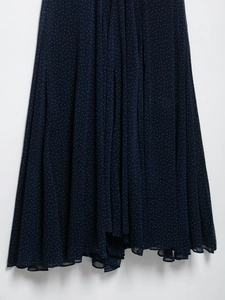 Detail of navy blue chiffon dress with white polka dot pattern and textured fabric