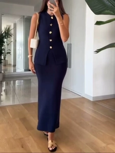Detailed shot of dark blue knit set with decorative gold buttons and split hem design