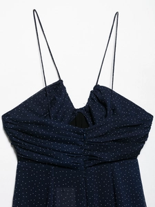 Detail of ruched chest and fine straps on navy blue polka dot summer dress