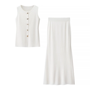 Detail of white two-piece knit set with buttoned sleeveless top and long skirt