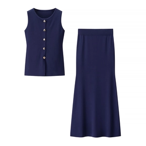 Detail of navy knit two-piece set featuring gold buttons on top and mermaid midi skirt