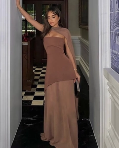 Detail of elegant dark brown halter neck maxi dress with asymmetrical mesh cape overlay