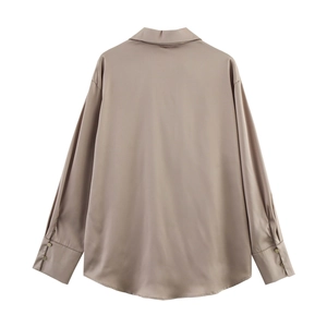Detail view of champagne satin shirt back showing soft drape and button cuffs