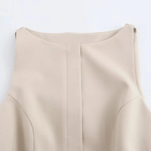 Detail of beige sleeveless dress neckline with professional woven fabric and vertical stitching