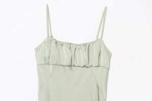 Detail of mint green satin camisole showing delicate spaghetti straps and pleated bust
