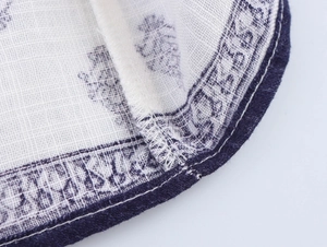 Close-up of ethnic floral print on linen-blend fabric with fine stitching details