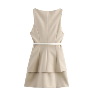Flat lay of sleeveless beige dress with thin white belt and layered hem detail