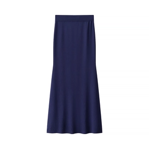 Detail of navy blue knit maxi skirt featuring a fishtail hem and elastic waistband