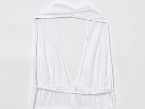 Detail view of white halter dress featuring deep V-neckline and adjustable waist drawstring