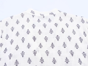 Close-up of vintage floral print collar and premium cotton fabric on white shirt