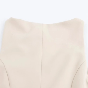 Detail of premium cream dress showing precise vertical stitching and fine woven texture