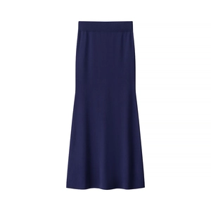 Detailed close-up of navy blue knit mermaid skirt with elastic waistband and flared hemline