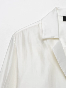 Detail of white satin shirt collar and smooth glossy fabric texture for elegant women