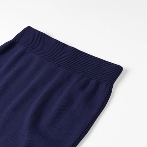 Detail view of the navy blue knitted waistband featuring elastic ribbed construction