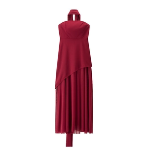 Detail of burgundy halter dress featuring irregular layered mesh hem and pleated texture