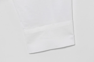 Detailed macro shot of white poplin cotton shirt cuff with premium stitching