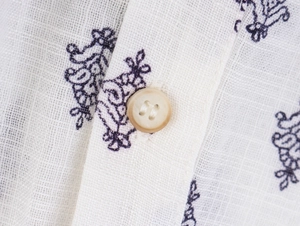 Detail of paisley print blouse showing linen texture and translucent button