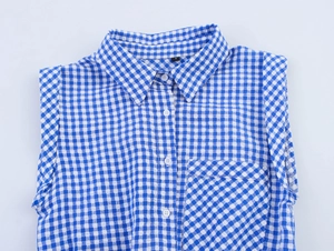 Detail of blue and white checkered sleeveless romper with buttons and square chest pocket