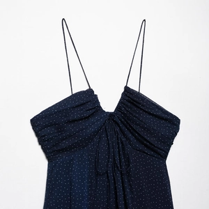 Summer dark blue polka dot dress featuring spaghetti straps and a V-neck pleated design