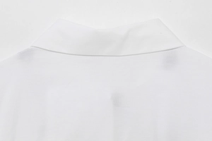 Close-up of the clean stitching and fabric texture on the white cotton shirt collar